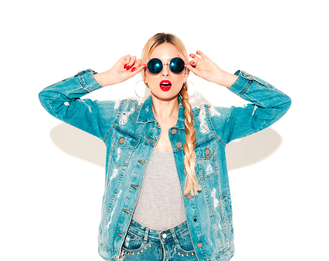 Model with long blonde braided hair wearing denim jacket